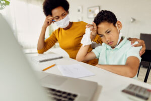 african american boy feeling stressed out while homeschooling with mother coronavirus epidemic scaled 1