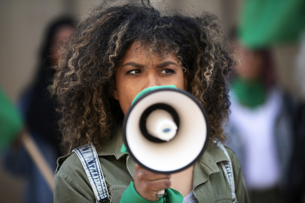 medium shot woman protesting outdoors